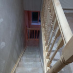 looking down stairway leading up to converted roof space