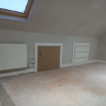 freshly plastered roof space with storage in the walls