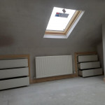 fresh plaster on loft conversion showing dormer window and in wall storage