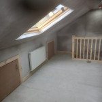 large dormer window installed in freshly plastered loft conversion.